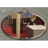 A vintage bevel edge oval wall mirror.