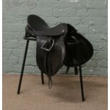 Lovatt & Ricketts general purpose black leather horse saddle with stirrups on stand, 16".