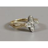 A 9ct gold diamond cluster ring set on split shoulders with a cross formation.