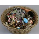 A basket containing a large quantity of costume jewellery.