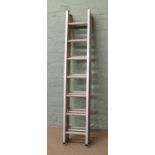 A triple extending aluminium ladder.