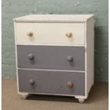 A painted pine three high chest of drawers.