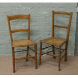 A pair of cane seat bedroom chairs.