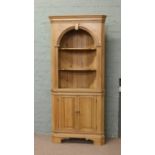 A pine barrel back corner cabinet of Georgian style.