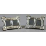 A pair of Art Nouveau style sterling silver miniature twin photograph frames.