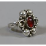 A modernist silver and cabochon garnet ring, size M.