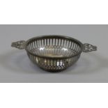 A pierced silver bon bon dish with open fret handles, assayed Birmingham 1947, 35 grams.