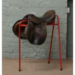 A general purpose tan leather horse saddle on stand, 17".