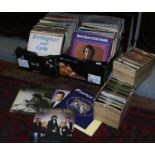 Four boxes of L.P and single records to include rock, pop and easy listening.