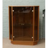 A retro teak corner display cabinet with smoke glass front.