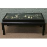 A Chinese lacquered rectangular coffee table with hardstone inset top depicting Geisha dancing in a