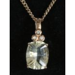 A 9ct rose gold pendant on chain set with an ovoid citrine and trio of diamonds.