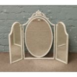 A dressing table triple mirror painted in white with gilt decoration.