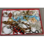 A tray of vintage costume jewellery including agate necklace and paste set brooches etc.