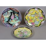 Three Japanese polychrome decorated dishes, one depicting a pair of Geisha girls in a landscape.
