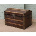 A vintage American wood bound dome top travel trunk.