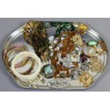 A tray of vintage costume jewellery including paste and simulated pearl brooches,