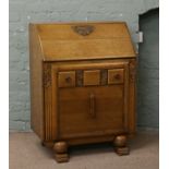 A 1940s light oak carved bureau.