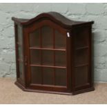 A continental dome top wall mounting display cabinet.