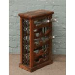 A hardwood wine rack with iron fretwork sides.