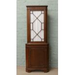 A mahogany corner cupboard with astrigal glazed top section.