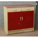 A 1950s Kompact kitchen side cabinet, yellow and red.