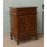 An Italian marquetry inlaid music cabinet.