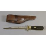 A folding hunting knife in leather sheath by Stan Shaw of Sheffield with release mechanism to the