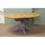 A sturdy painted centre pedestal extending dining table with plain beech top.