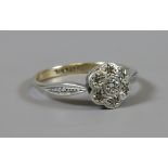 9ct gold and silver daisy cluster ring set with diamond chips c1940, size N.