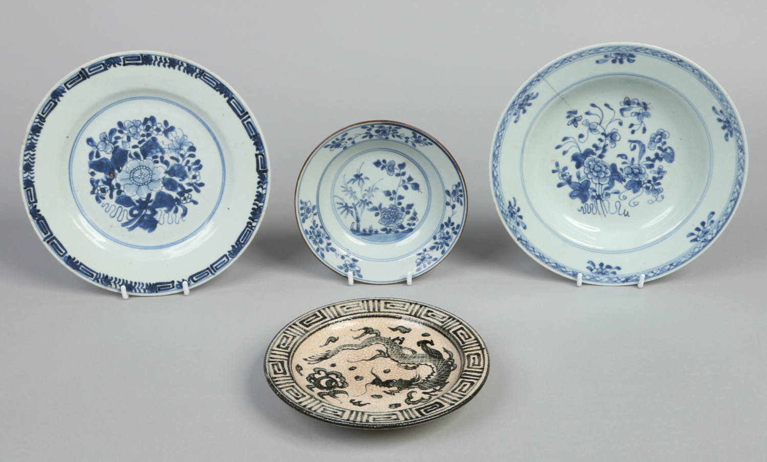 Three 18th century Chinese blue and white plates and a later Ming style crackle glazed dish