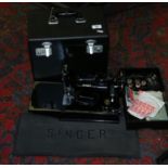 A cased electric Singer sewing machine.