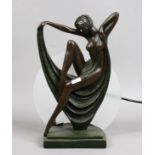 A bronze effect Art Deco tablelamp formed as a semi naked girl.