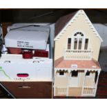A dolls house and two boxes of dolls house furniture.