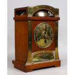 An Arts and Crafts oak cased eight day mantel clock with brass mounts in the manner of Archibald