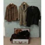 A vintage suitcase and contents of six fur coats.