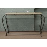 A wrought iron and yellow marble console table.