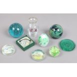A group of glass paperweights and a Bohemian glass vase.