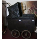 A vintage dolls pram with canopy.