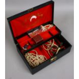 A leather jewellery box and contetns of vintage costume jewellery.
