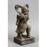 A Chinese carved wood small statue of a warrior with gesso decoration.
