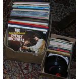 Two boxes of L.P records and 7 inch singles mostly classical and easy listening.
