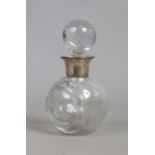 A cut glass decanter formed as a lawn bowl with silver collar,