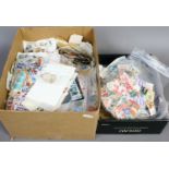 Two boxes of loose world stamps.