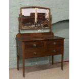A Victorian mahogany dressing table with bevel edge mirror.