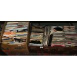 A box and suitcase of 45 records to include mainly rock and pop.