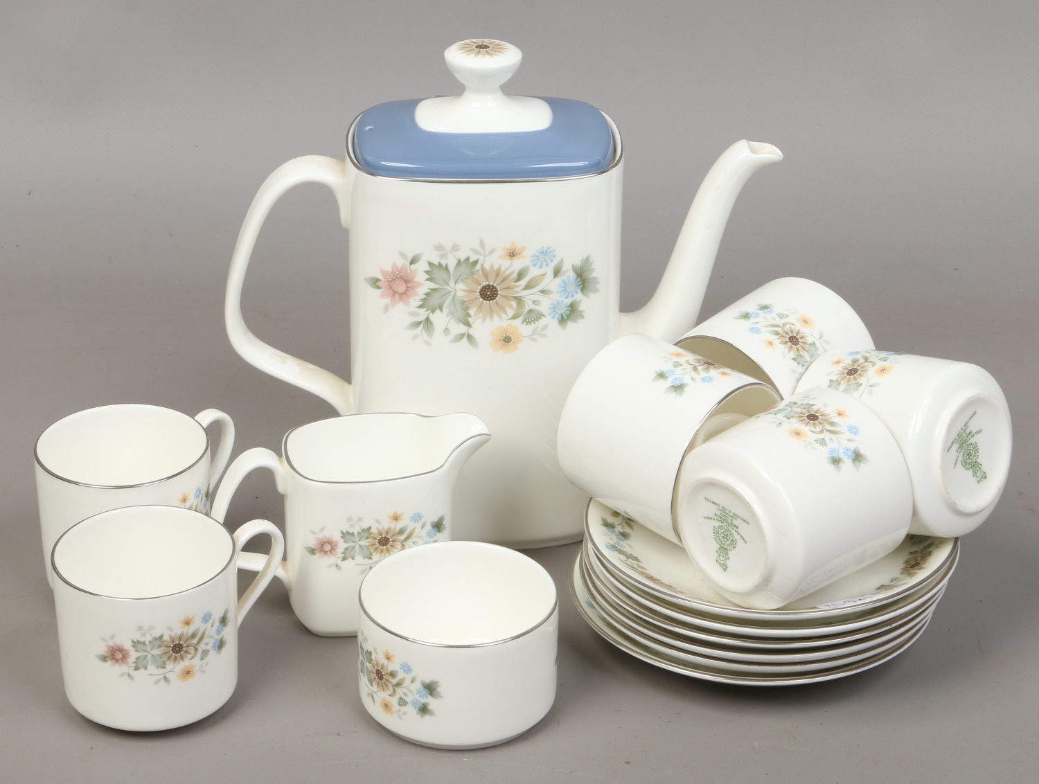 A Royal Doulton bone china service decorated in the pastoral design including a teapot, sugar bowl,
