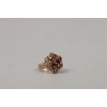 A yellow metal garnet cluster ring, size I1/2.