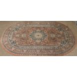 A Royal Instanbul pink ground oval rug with floral design,