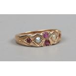 A 9ct gold ring set with rubies and seed pearls, maker S. B. & S. Size N.